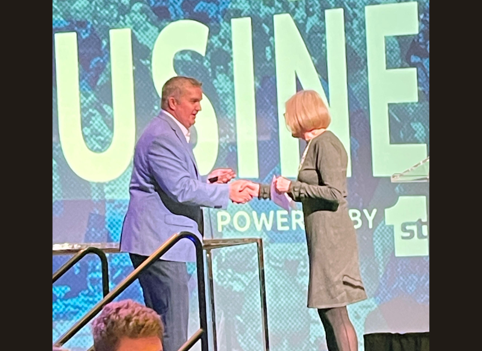 Laurie shakes hands with Chamber of Commerce representative